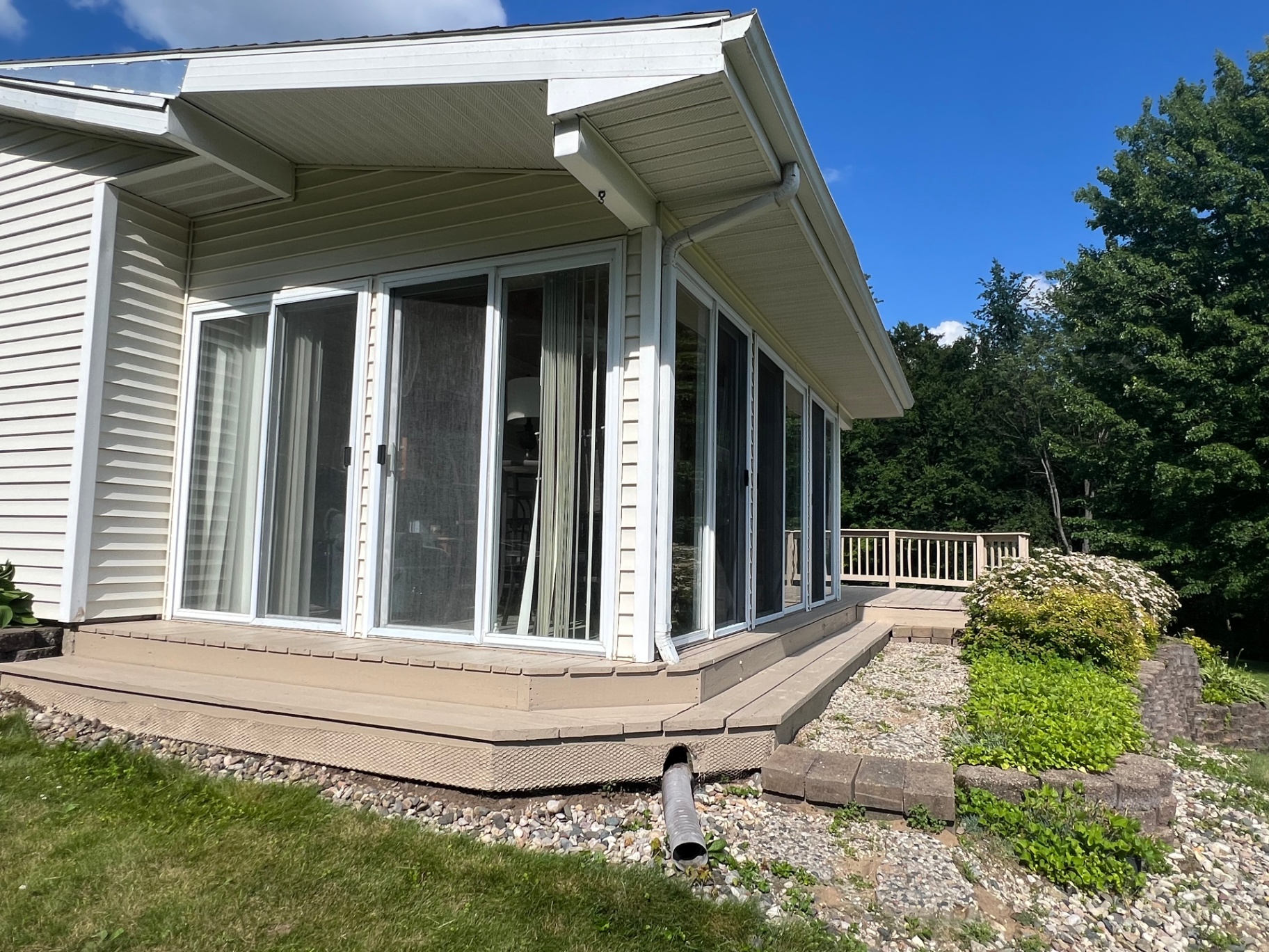 Freshly painted deck along a wall of sliding glass doors