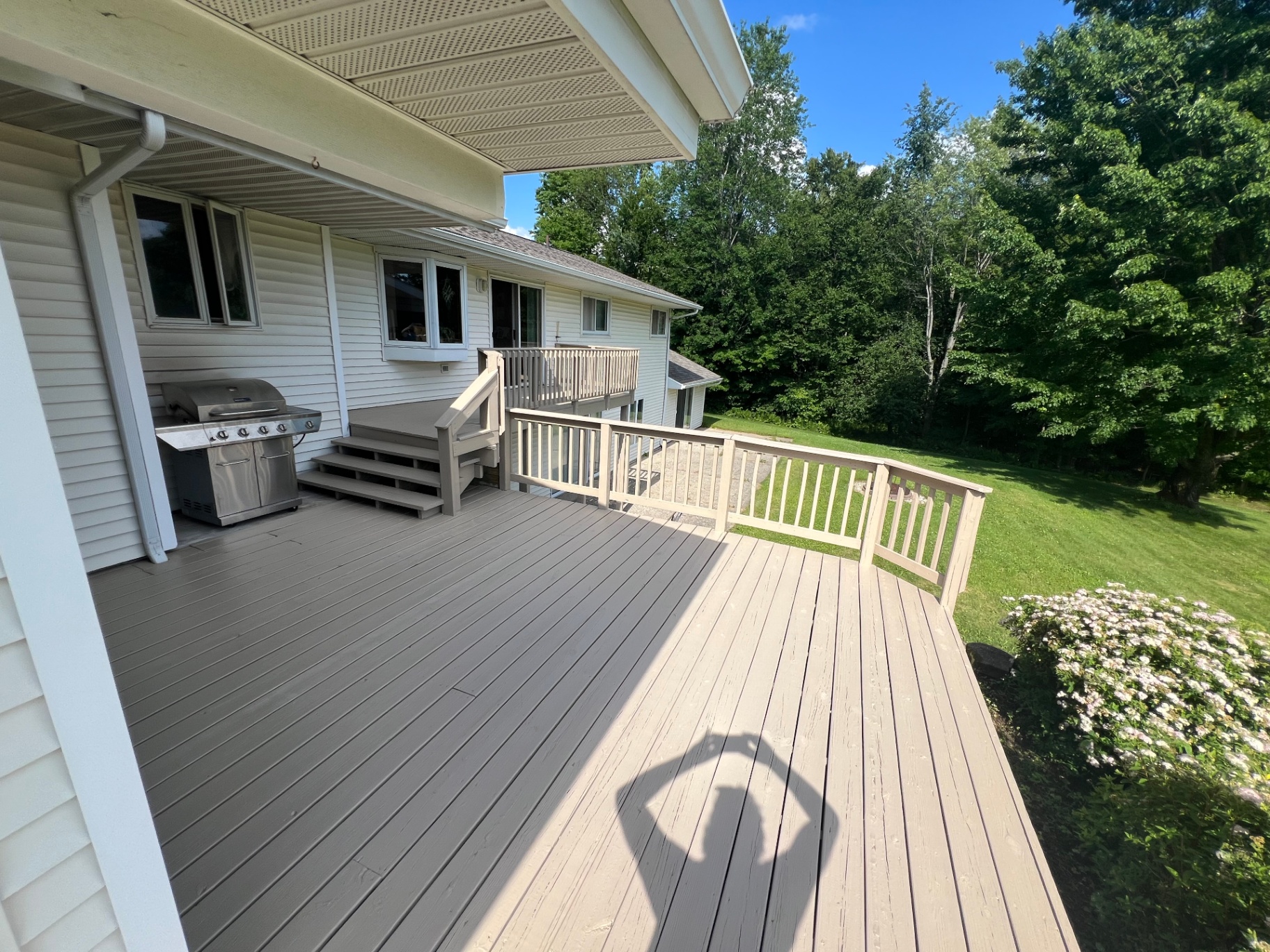 Refinished deck floor and railing in warm neutrals