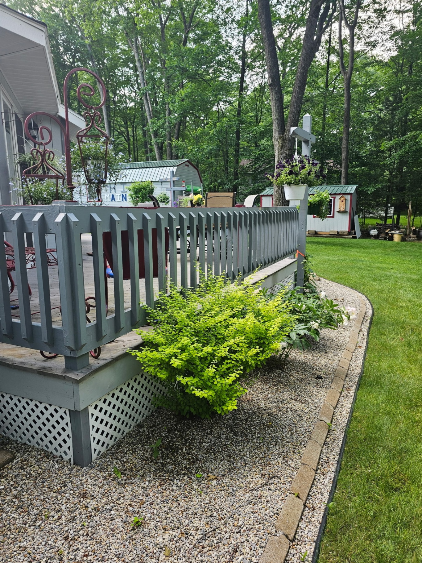 Detailed deck rail painting with landscaped surround